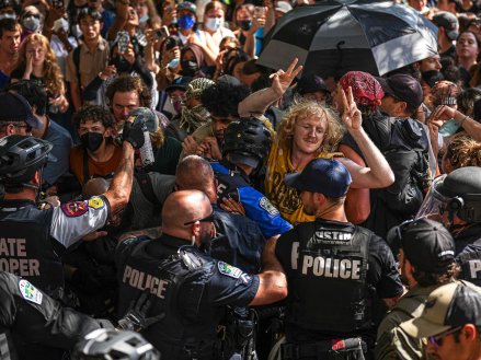 Protesters block police vehicles from leaving the University of Texas at Austin on Monday, April 29, 2024